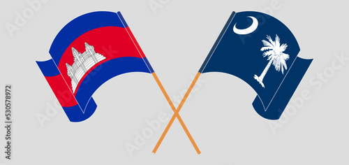 Crossed and waving flags of Cambodia and The State of South Carolina