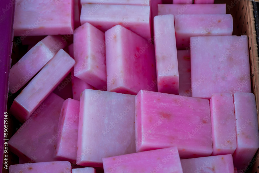 pile of handmade pink soap in box. Selective focus pink soap