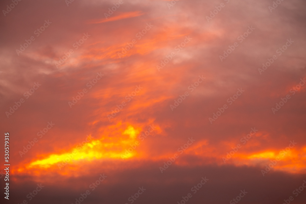 Beautiful gradiant orange clouds and sunlight on the blue sky perfect for the background, take in everning,Twilight, rainy season,winter, summer