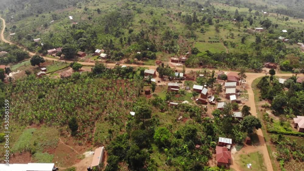 Drone shot over the slum village of Uganda, with green palm trees, clay houses.. High quality 4k footage Drone shot over the slum village of Uganda, with green palm trees, clay houses.. High quality 4k footage
