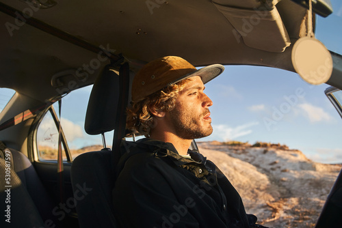 Side view of the focused man in cap smoking and thinking about something photo