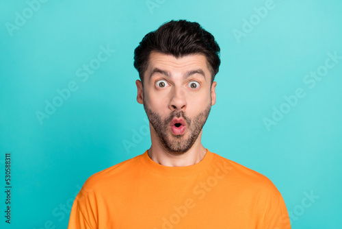 Closeup photo of young handsome bearded student guy wear orange t-shirt pouted lips speechless shocked new prices isolated on aquamarine color background