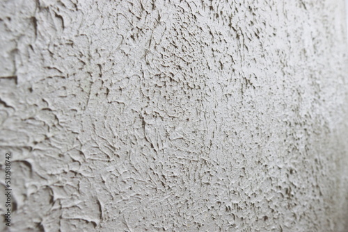 The grainy texture of wall plaster.