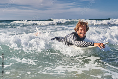 Extreme positive surfer riding ocean waves and smiling to the camera © Yakobchuk Olena