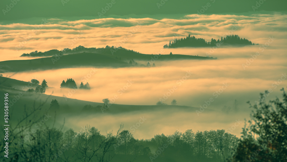 Fantastic view of the tops of the mountain ridge above the clouds