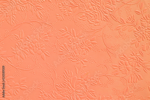 Tooled floral pattern in orange leather.