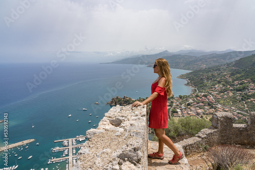 Portrait of a beautiful blonde woman contemplating the incredible views in Sicily, Italy