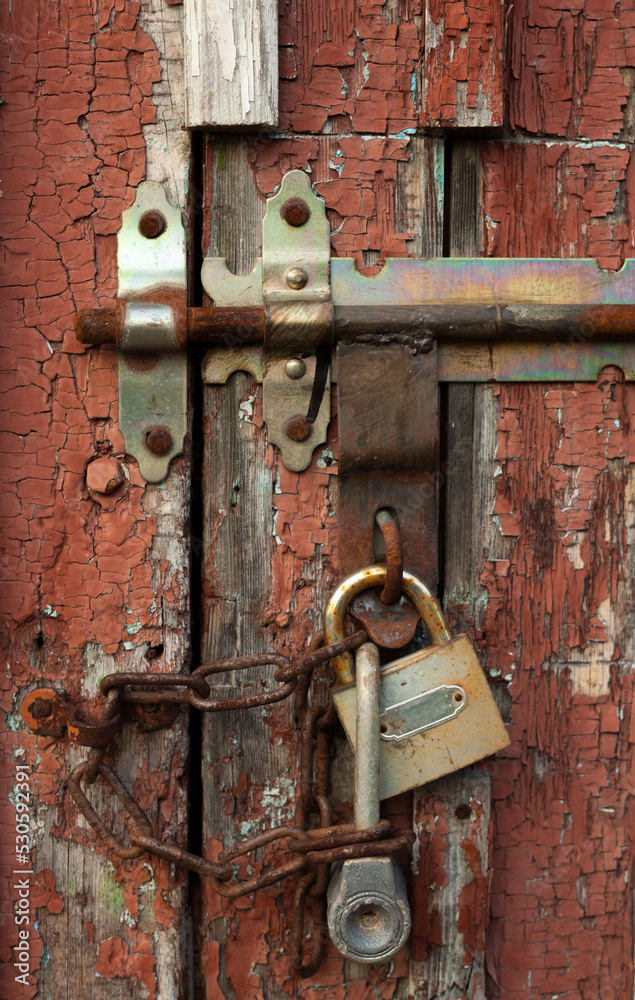 Old door with padlock and latch. Old door with padlock and latch.