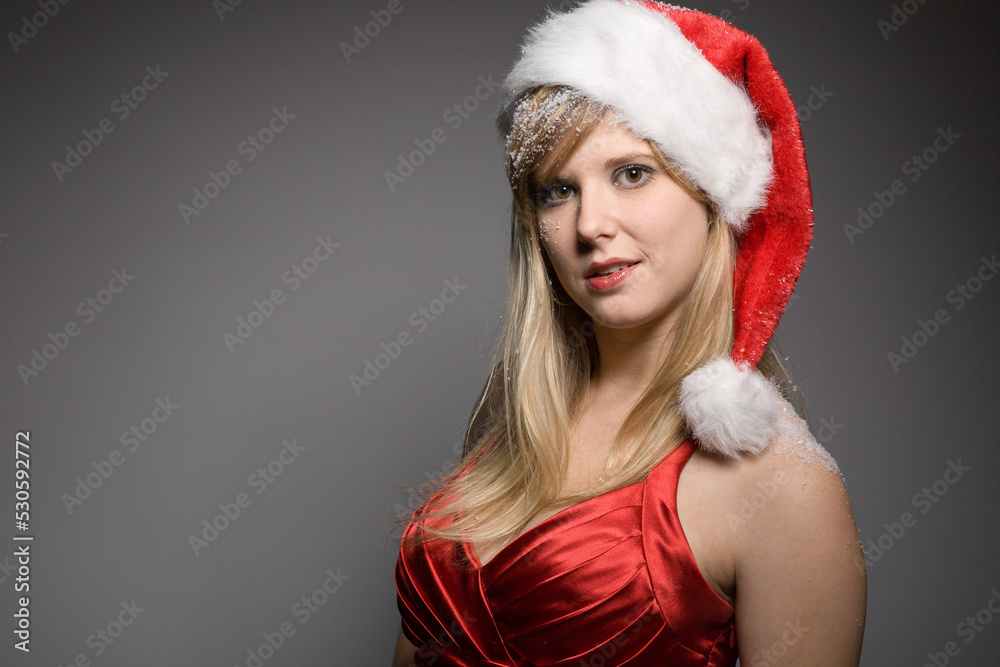 young pretty blonde christmas woman with santa claus hat in front of a grey background young pretty blonde christmas woman with santa claus hat in front of a grey background