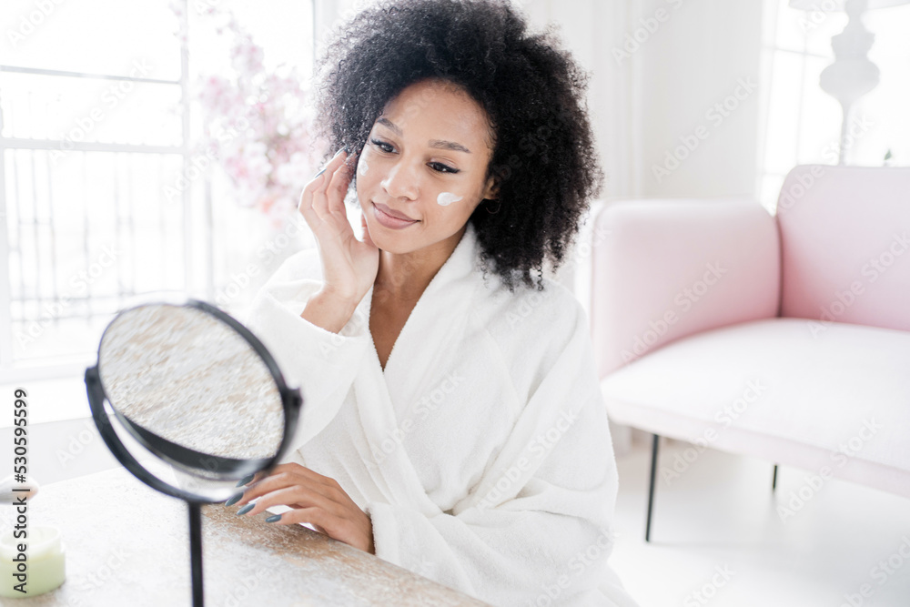 Applies a face cream on an environmentally friendly base. Woman skin care with cosmetics. Applies a face cream on an environmentally friendly base. Woman skin care with cosmetics.