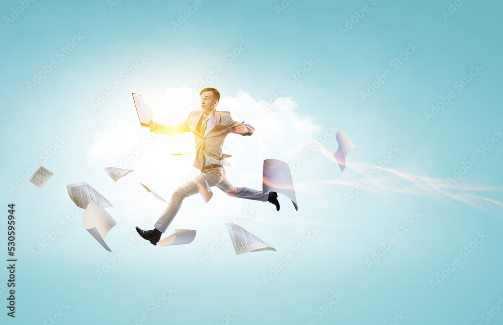 Portrait of energetic businessman jumping in open air