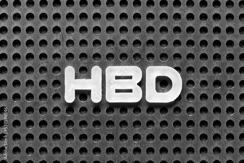 White alphabet letter in word HBD (Abbreviation of happy birthday) on black pegboard background