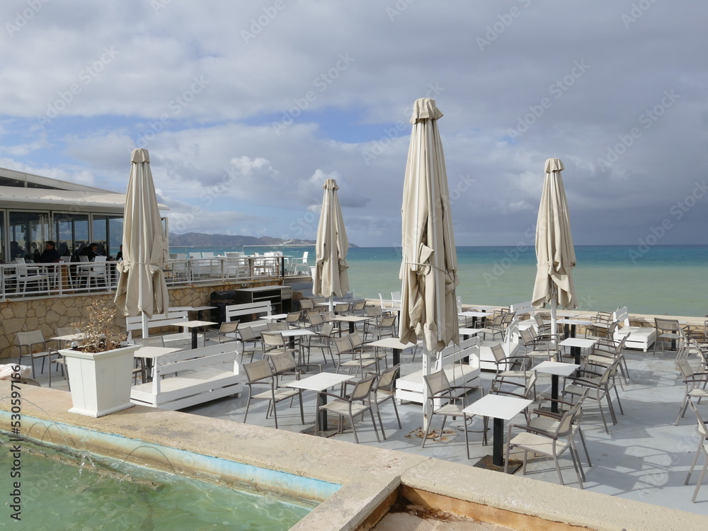 Fototapeta premium Tables and umbrellas on the Heraklion waterfront, Heraklion, Crete island, Greece