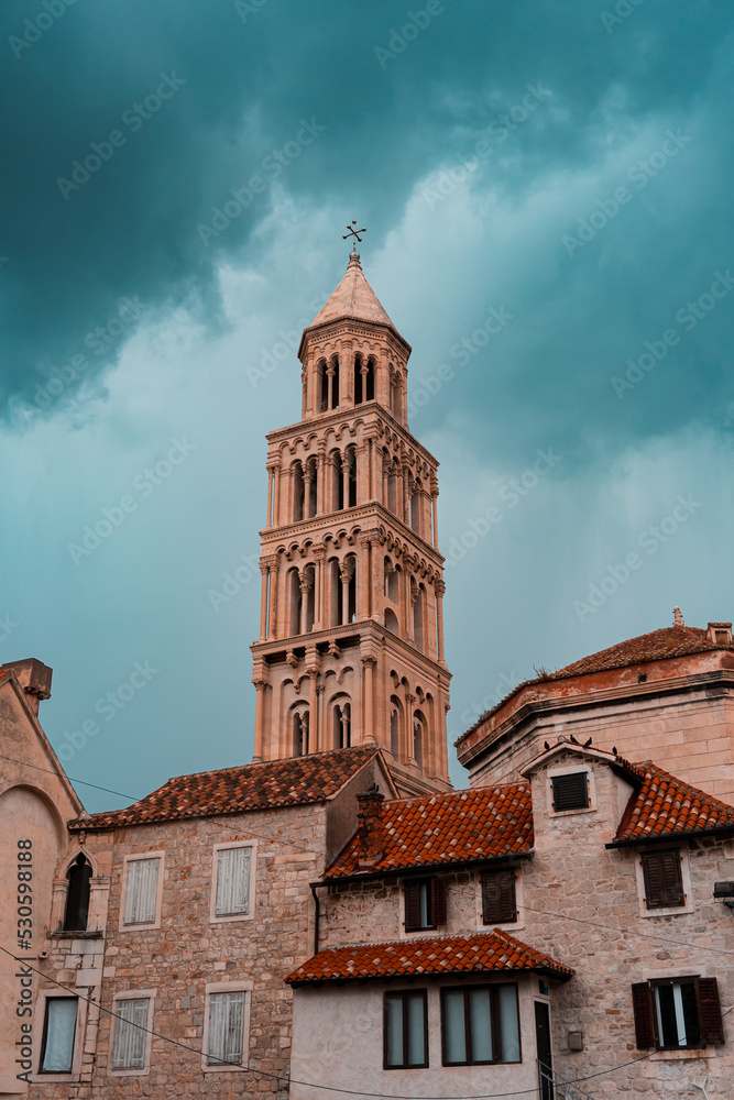 church tower (steeple) in the middle of an old town with dramatic weather/clouds in Split, Croatia