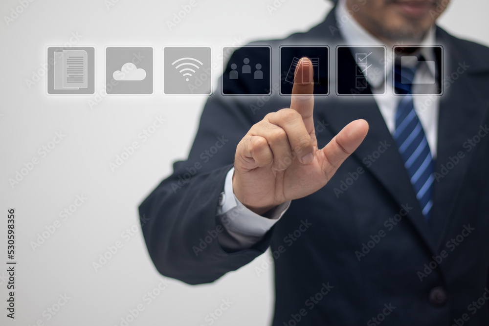 Businessman touches the screen with a finger to select an icon. Businessman touches the screen with a finger to select an icon.