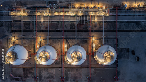 Aerial view spherical tanks for petrochemical plant at night, Industrial gas storage tank, Spherical Gas petroleum refinery, Natural gas tank liquefied natural Industrial Spherical gas storage tank.