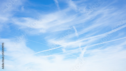 Air pollution from airplanes background / conspiracy  - Chemtrails over the blue cloudy sky