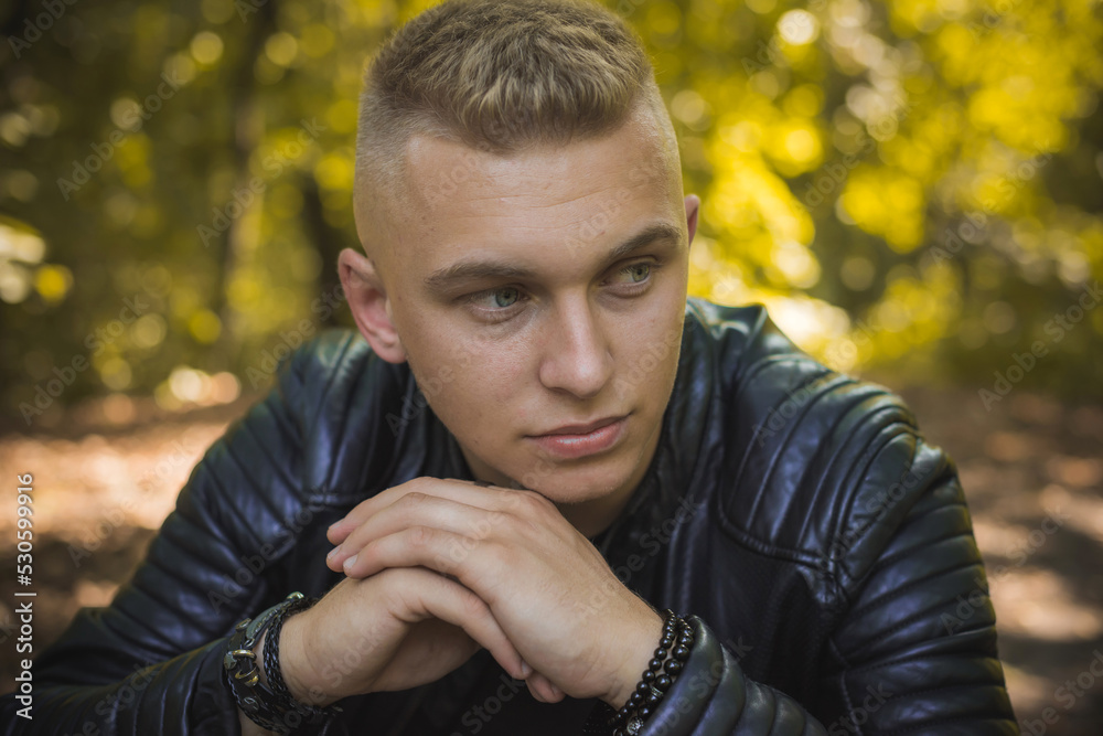 Fototapeta premium Young blonde Nordic appearance guy, style for youth accessorize for men, casual street style