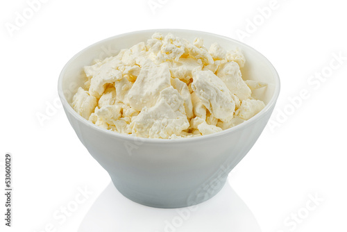 Home made cottage cheese in a white bowl on a white background isolated