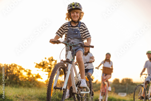 Happy family cycling together in the countryside 