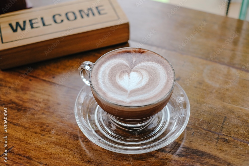 Coffee cup and latte art on wooden top table background. Coffee cup and latte art on wooden top table background.