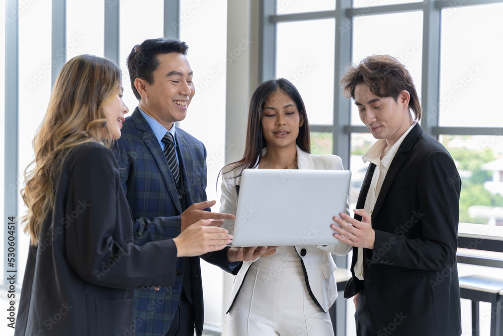 A group of young Asian businessmen Talking and planning work happily and have fun. at the company's office