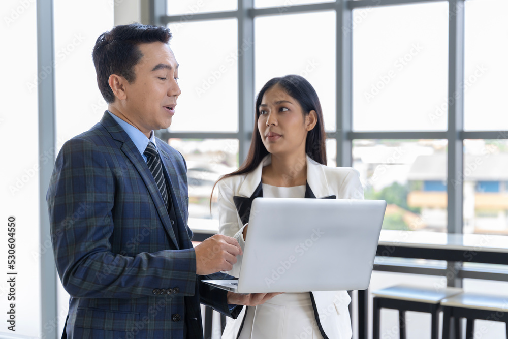 A group of young Asian businessmen Talking and planning work happily and have fun. at the company's office A group of young Asian businessmen Talking and planning work happily and have fun. at the company's office