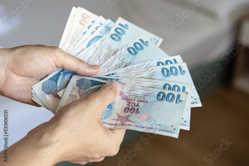 Man holds a pack of Turkish lira. Cash withdrawal in Turkey photo