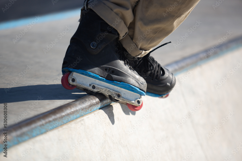 Inline Skater Grinds On Rail In Skatepark Roller Blader Grinding
