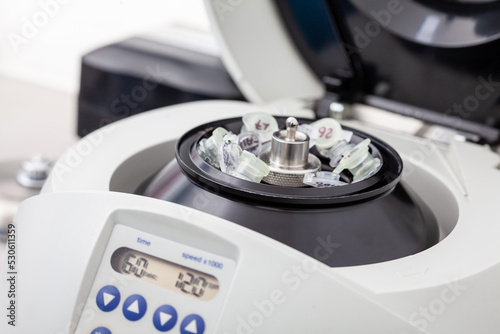 Table centrifuge filled with tubes. Spin column-based nucleic acid purification technique.