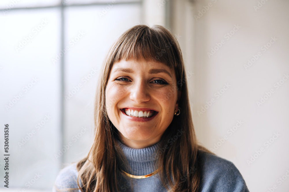 Successful businesswoman smiling at the camera in an office Successful businesswoman smiling at the camera in an office