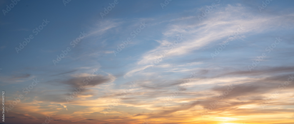 sky sunset. Real amazing panoramic sunrise or sunset sky with gentle colorful clouds. wide panorama. Panorama of orange sunset sky with bright sun
