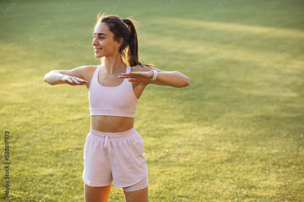 Young woman stretching before workout on fresh air Young woman stretching before workout on fresh air