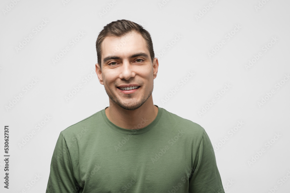 smiling caucasian man about 30 years old in green t- shirt on white background, male portrait smiling caucasian man about 30 years old in green t- shirt on white background, male portrait