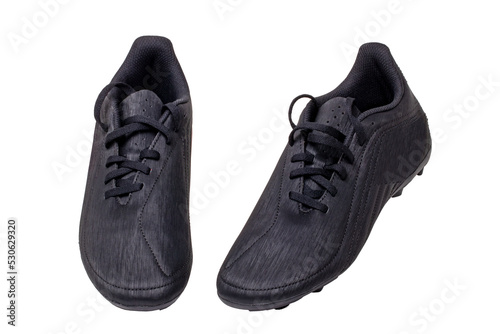 Closeup of a pair of black leather football boots isolated on white background. Professional athletics boys outdoor training shoes. Sports shoes.