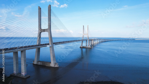 Lisboa, Portugal, April 24, 2022: Aerial view of the Vasco da Gama Bridge is a cable-stayed bridge located in the city of Lisbon and crosses the Tagus River. It is the second-longest bridge in Europe.