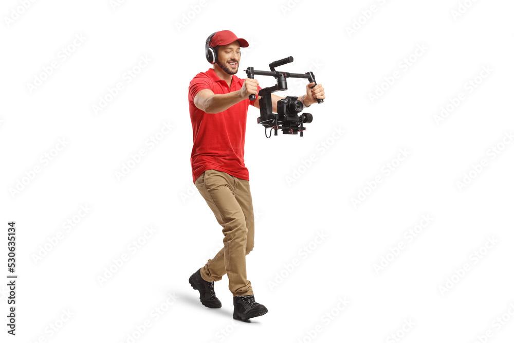 Full length shot of a camera operator walking and using a camera stabilizer Full length shot of a camera operator walking and using a camera stabilizer