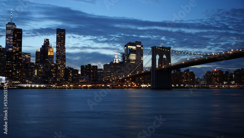 Elevated bridge over the river and city in the background with night time © Ivn