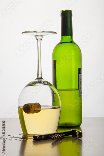 A cork, misteriously floating in a wine glass upside down.