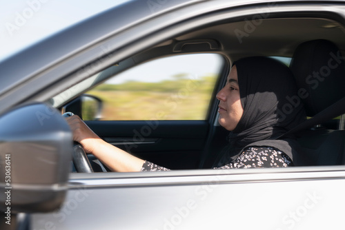 Close up of muslim woman driving a car