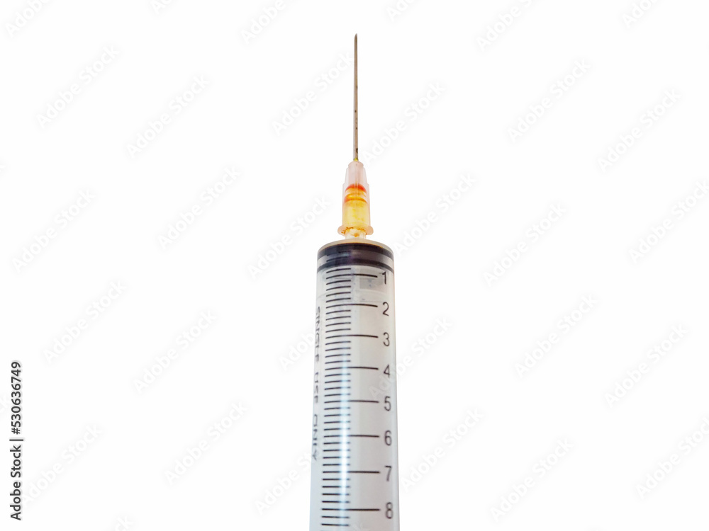 Syringe on a white background with orange ink. Syringe on a white background with orange ink.