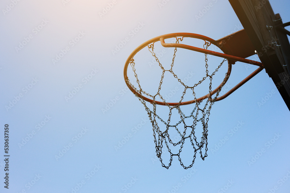 close up of basketball hoop. Basketball court outdoors, metal net and backboard for basket ball game outside. Recreational sport equipment on streetball field alfresco, playground on street.