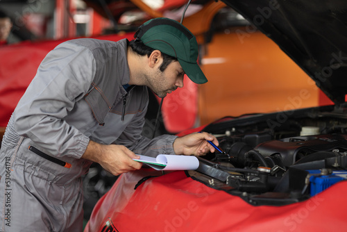 Automobile mechanic man checking car damage broken part condition. diagnostic and repairing vehicle at garage automotive, Concepts of car care check and fixed and services insurance. © Shutter B