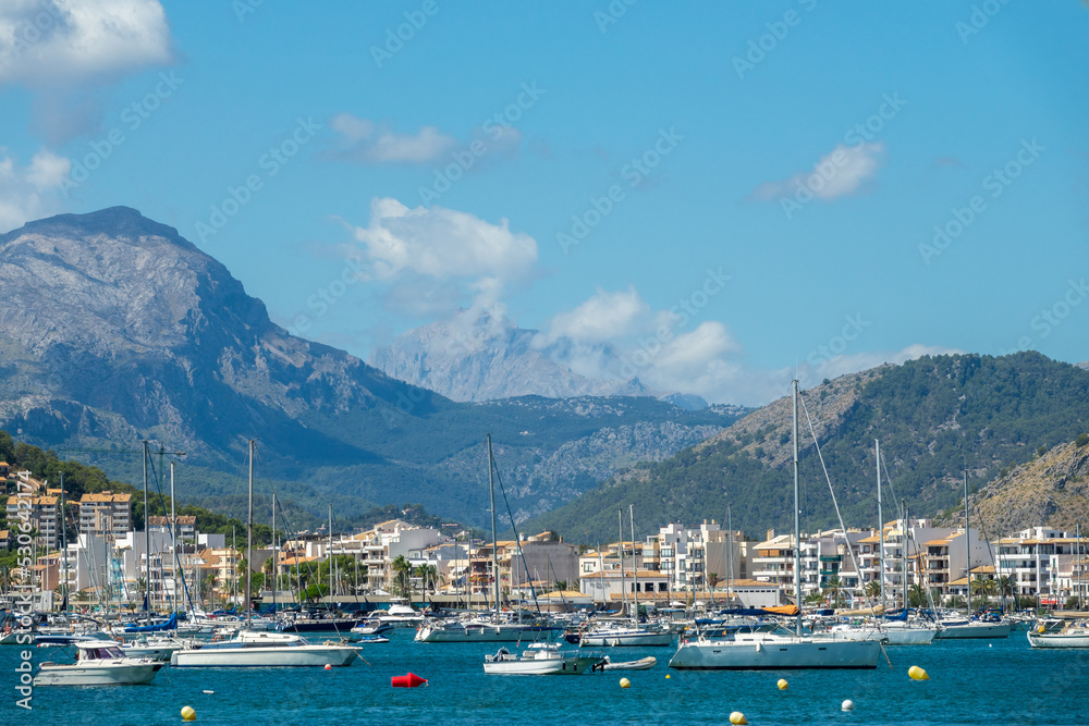 View of the port of Pollença (Spain) with the Puig Major in the background on a sunny summer morning
