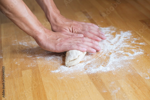 Man kneading dough for baking