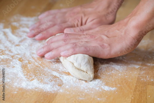 Person preparing dough for bread close-up