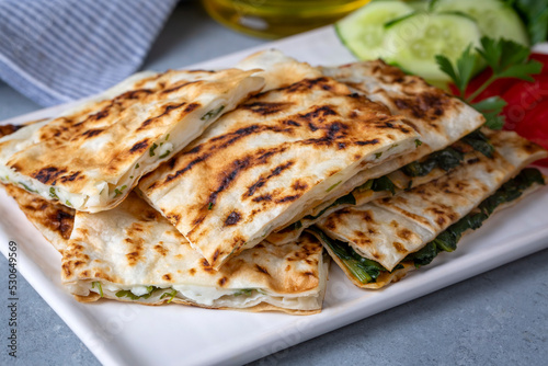 Traditional Turkish food, Turkish pancake gozleme with cheese and herb. The appetizer is Turkish pastry. There are varieties such as cheese, spinach, potato.