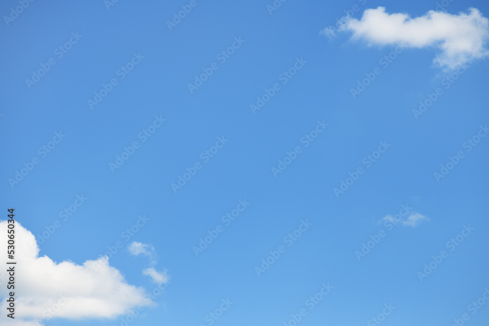 Blue sky background with small white clouds in corners Blue sky background with small white clouds in corners