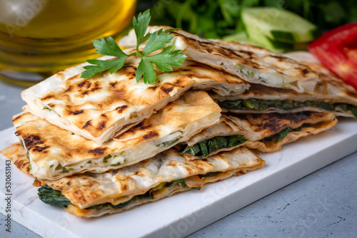 Obraz na płótnie Traditional Turkish food, Turkish pancake gozleme with cheese and herb. The appetizer is Turkish pastry. There are varieties such as cheese, spinach, potato w salonie