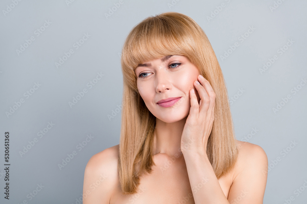 Portrait of tender skin mature lady apply balm silky aesthetic skin touch hands isolated over grey color background Portrait of tender skin mature lady apply balm silky aesthetic skin touch hands isolated over grey color background